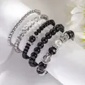 Set de cinco pulseras elásticas de cristal negro y cuentas de plata en soporte blanco - Juego Negro/Gris Oscuro/Plateado (SY0349-1)
