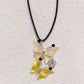 Close-up of yellow butterfly pendant with rhinestones and black beads on a black cord - Yellow Style (C24-113F M-F2-6)