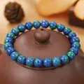 Pulsera de cuentas naturales en azul y verde mostrada sobre una tapa de tetera de barro - Estilo Primitivo Azurita Crisocola (ZJ14016)