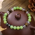 Tiger eye and clear crystal beaded bracelet on a vintage ceramic teapot lid background - Green Clear Brown Gray Multicolor Style (ZJ13500)