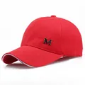 Red cotton baseball cap with silver metal M logo and white trim on the curved brim - Adjustable / Red
