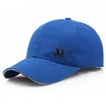 Navy blue baseball cap with metallic M logo and white trim on the curved brim - Adjustable / Blue