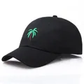 Classic black cotton baseball cap featuring green palm tree embroidery on a curved brim - Adjustable / Black