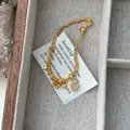 Gold beaded bracelet with clover charm and opal stone pendant in a luxury jewelry box - Gold / 15.5cm