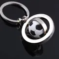 Macro detail of rotating metal football keychain with polished finish on black background - Rotating Football Style (GX-071)
