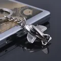 Polished silver metal airplane keychain with detailed 3D wings on reflective surface - GX-053 Fighter Jet