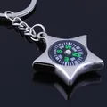 Polished silver star-shaped metal keychain with functional compass on black background - Pentagram Compass Style
