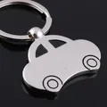 Polished silver alloy classic car keychain with metal ring on black mirror background - Vintage Car Style / Silver