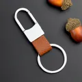 Polished silver metal and brown leather keychain on a dark background with acorns - Brown (GX-171)