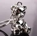 Polished silver metal teddy bear keychain with glossy finish on reflective dark surface - Mechanical Bear Style (GX-012)