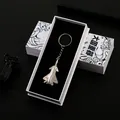 Silver alloy fighter jet keychain model presented in a premium black and white gift box - J-20 Fighter Jet With Gift Packaging (A-037)