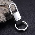 Executive metal and black leather keychain with a polished silver hook on stone background - Nickel