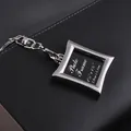 Mini silver square photo frame keychain with elegant curved edges on leather background - Rhombus Frame Style