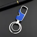 Macro detail of silver metal keychain with blue textured handle and integrated bottle opener - Blue