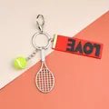 Fluorescent yellow tennis ball keychain with red LOVE ribbon and silver racket - Tennis Racket Ball And Red LOVE Ribbon
