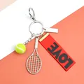 Tennis racket keychain with yellow ball and red LOVE ribbon strap in vibrant colors - Tennis Racket Ball Red Ribbon And Blank Tag