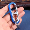 Blue metal car keychain with multifunctional bottle opener and dual rings in hand - Blue