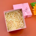Square pink gift box with ribbon bow and raffia filler for jewelry and small gifts - Pink Bow Gift Box