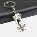 Polished silver F1 racing car keychain on premium black leather and grey background - Silver Racing Style (GX-054 Racing Car)