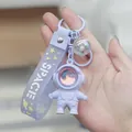 Purple astronaut keychain with glowing light and space themed silicone strap for bags - Sunset Lamp Astronaut-Purple