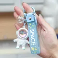 Light blue astronaut keychain with LED glow, iridescent sphere, and space strap - Sunset Lamp Astronaut-White