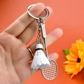 Close-up of alloy badminton racket and white PVC shuttlecock on a keychain charm - Badminton Racket With White Shuttlecock / White