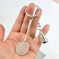 Handheld silver metal badminton racket and shuttlecock keychain with a polished finish - Badminton Racket Shuttlecock (A-003)