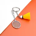 Creative silver metal badminton racket keychain with a vibrant yellow shuttlecock charm - Badminton Racket With Yellow Shuttlecock / Yellow