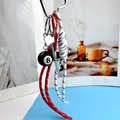 Detail of No.8 billiard ball keychain with silver key charm and woven cord straps - Red and White