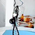 8-ball keychain with silver heart buckle and dual-tone braided cords in street style - Brown And White Cord