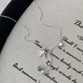 Silberne Seesternkette mit blauem Zirkonia-Muschel-Anhänger und weißer Perle - Halskette / 925er Silber