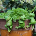 Set of three resin frog garden figurines hanging on a plant pot edge for decoration - Back Hanging Frog