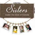 Dark brown wood photo display with white Sisters quote, twine rope and eight wooden clips - Sisters Slogan