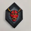 Japanese Hannya mask wall decor with red face and gold horns in a black hexagonal frame - Red