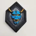 Blue Hannya mask wall decor with golden horns in a black hexagonal frame - Sky Blue
