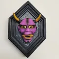 Purple Hannya devil mask in black hexagonal frame with gold horns and teeth wall decor - Purple