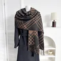 Detailed view of the thick plaid scarf with soft fringe edges and cashmere-like texture - Diagonal Stripe Black Camel