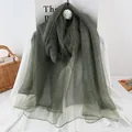 Detail view of the fine horizontal texture on this lightweight dark green silk scarf - 190x70 / Dark Green
