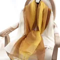 Elegant gradient yellow and amber silk wool scarf displayed on a vintage chair - 190cm / Yellow Gradient