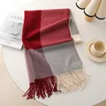 Red grey and beige plaid wool shawl with long fringes in a cozy winter setting - Red Grey