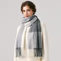 Gray and white plaid wool blend scarf with decorative tassels worn by model - Black & White