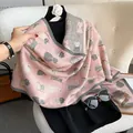Detail of pink and grey cat pattern scarf featuring elegant brown fringe and knit texture - Pink
