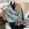 Detail of blue and orange scarf featuring cartoon cat patterns and fine fringe edges - Lake Blue