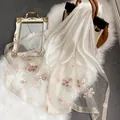 Détail de la broderie de fleurs roses sur une écharpe en soie ivoire aux bords scintillants - 195CM / Blanc Lait