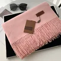 Elegant pale pink cashmere-feel scarf with fringe details and a leather brand tag - Soft Pink