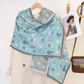 Light blue scarf featuring cute cat prints and tassel edges on a beige coat - Water Blue Grey