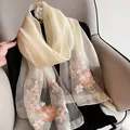 Detailed close-up of light champagne silk wool shawl with elegant floral embroidery - 195CM / Milk White