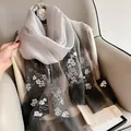 Detail of floral butterfly embroidery on gray gradient silk wool shawl with sheer texture - Gradient Black