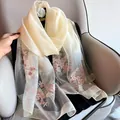Elegant beige silk wool shawl featuring delicate pink floral embroidery on sheer fabric - Milk White
