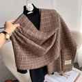 Detail of soft brown plaid cashmere scarf texture with tassels and woven brand label - Brown Plaid (Type E)